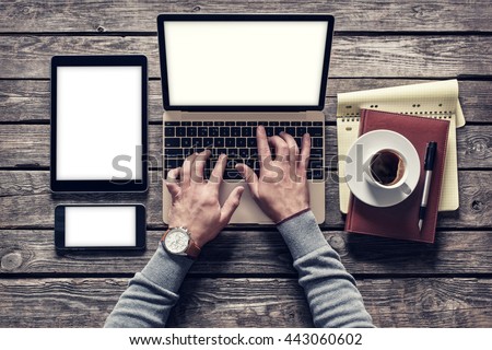 Top view of writer's workplace - laptop and tablet pc with cup of coffee. Clipping paths included.