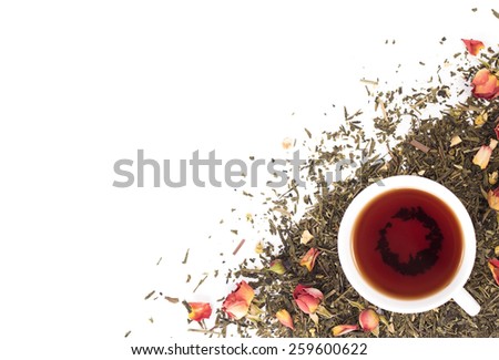 cup of tea on background dry rosebuds. View from above.