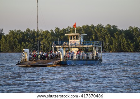GO CONG, VIETNAM - MAY 07, 2016 - Tourists and cars loaded on a ferry and headed for the Go Cong Isle, Tien Giang province, Vietnam
