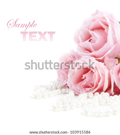 Beautiful pink roses and white pearls isolated over white background. Closeup flower bouquet and jewels with copyspace.