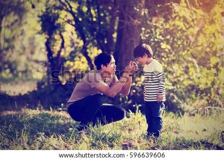 Vintage color photo happy joyful father having fun and son, family, travel, father's day - concept. Sunlight