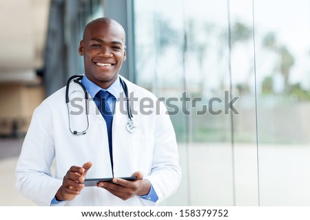 happy african male doctor with tablet computer