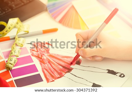 Fashion designer working in studio. Close up design.