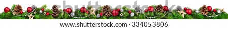 Extra wide Christmas border with fir branches, red and silver baubles, pine cones and other ornaments, isolated on white