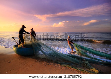 Beach Lagi, Binh Thuan province, Vietnam - August 29, 2015: Unknown Fishermen who pull up th are the fishing nets khi sunrise. This is ask for their daily work