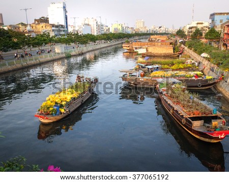 Hochiminh City, Vietnam - February 4, 2016 - the annual Lunar New Year, many boats loaded with many kinds flowers from the garden in the southwest through the canals, forming a large flower market