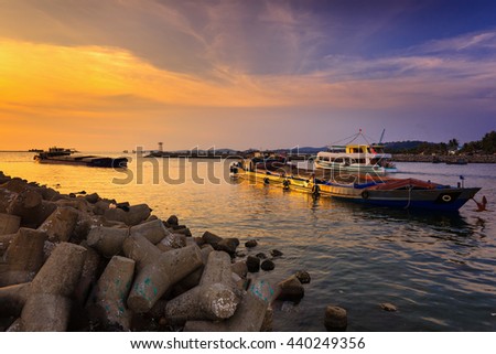 Phu Quoc island, Kien Giang province, Vietnam - May 02, 2016: amazing sunset at breakwater pier on Phu Quoc island . scene the boats were operating on the river to prepare to the sea in the sunset