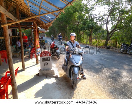 Ha Tien Town, Kien Giang province, VietNam - April 30, 2016 : woman resting after a long trip picnic by motorcycle