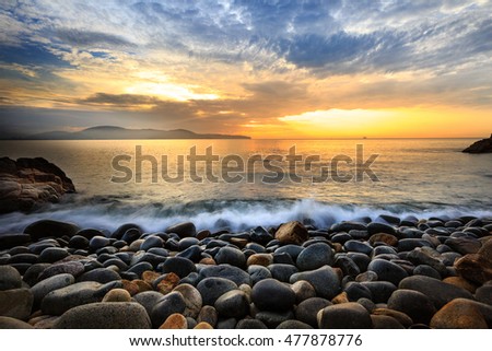 Long exposure of sea and stones, beautiful sunrise in Quy Nhon city, Vietnam