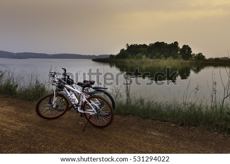 Flamingo Dai Lai, Vinh Phuc, Vietnam - October 10, 2016: Two bicycles beside the lake at sunset