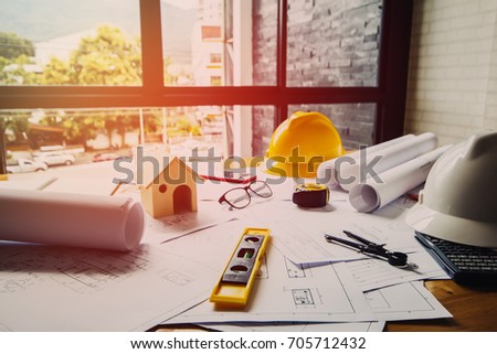 Concept architects, equipment architects
On the desk with a blueprint in the office, Vintage, Sunset ligth.Selective Focus