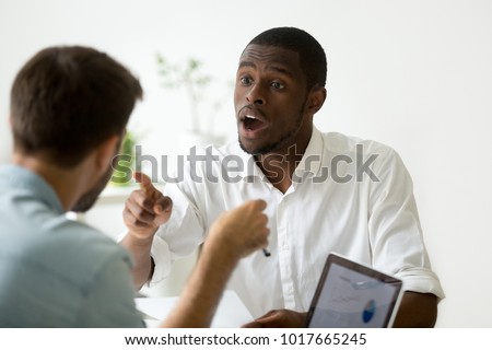 African american businessman disagreeing arguing debating during office negotiations, black negotiator disputing with caucasian partner, insisting on point of view in discussion, explaining opinion