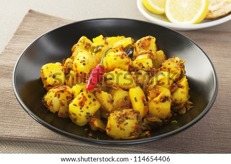 A dish which is an invention of the Western curry houses, Bombay Potato is a hot and spicy accompaniment for curry or maybe steak, or can be eaten as a snack with bread - stock photo