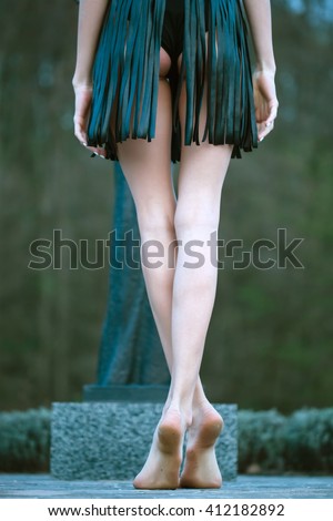 https://thumb9.shutterstock.com/display_pic_with_logo/2810074/412182892/stock-photo-barefoot-woman-in-short-black-leather-skirt-with-beautiful-buttocks-standing-with-back-on-road-in-412182892.jpg