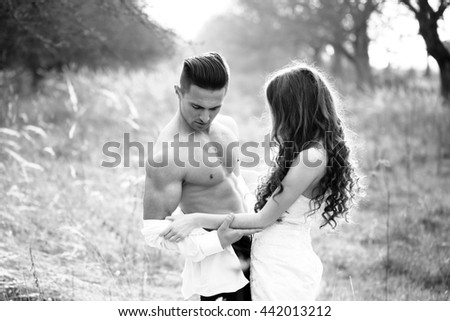 https://thumb9.shutterstock.com/display_pic_with_logo/2810074/442013212/stock-photo-young-happy-wedding-couple-of-pretty-woman-and-man-undressing-in-field-outdoor-black-and-white-442013212.jpg