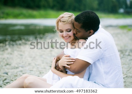 https://thumb9.shutterstock.com/display_pic_with_logo/2810074/497183362/stock-photo-romantic-couple-of-man-handsome-african-american-and-pretty-girl-beautiful-woman-embrace-near-river-497183362.jpg
