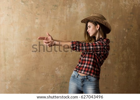 thumb9.shutterstock.com/display_pic_with_logo/2810074/627043496/stock-photo-cowboy-girl-or-pretty-woman-with-blond-long-hair-in-stylish-hat-and-red-plaid-shirt-showing-finger-627043496.jpg
