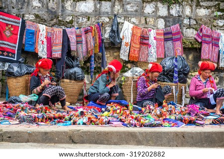 SAPA, VIETNAM - September 10,2015 : Hmong woman on the main street of Sapa on September 10,2015 in Sapa, Vietnam. Hmong people are costumes and ornate silver jewellery to sell handmade goods.