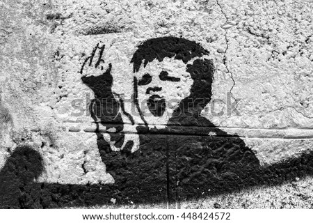 Mbappé té de thune Stock-photo-graffiti-on-the-wall-angry-kid-fuck-you-448424572