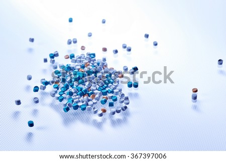 Tinted chemical granules closeup on pattern background