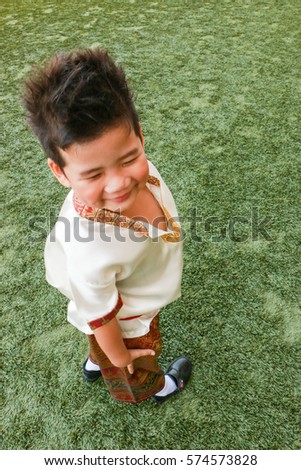 A Cute Boy In Thai Dress Stand On The Yard A Cute Boy In Thai Dress Stand On The Yard