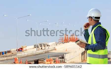 Engineers on construction sites, road and bridge.