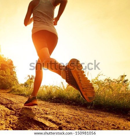 Young lady running on a rural road