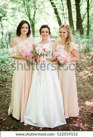 https://thumb9.shutterstock.com/display_pic_with_logo/2988610/522059152/stock-photo-happy-and-young-bride-and-her-bridesmaids-standing-together-522059152.jpg