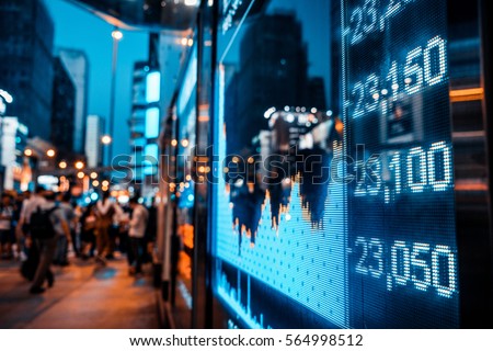 Display of Stock market quotes with city scene reflect on glass