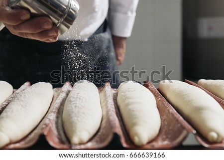 Baker making bread at a bakery. Bakery Concept.