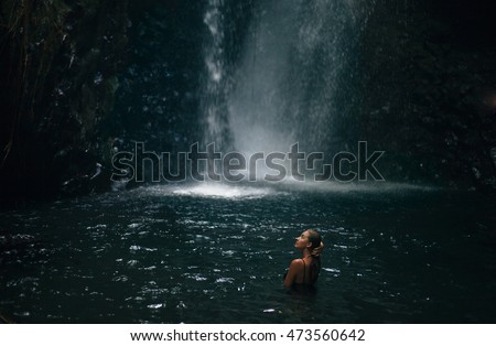 https://thumb9.shutterstock.com/display_pic_with_logo/3026723/473560642/stock-photo-pretty-woman-posing-on-black-swimsuit-on-the-waterfall-enjoy-the-nature-alone-spa-procedure-look-up-473560642.jpg