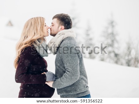 https://thumb9.shutterstock.com/display_pic_with_logo/3042905/591356522/stock-photo-woman-holds-man-s-hands-on-her-pregnant-belly-and-leans-to-him-for-a-kiss-591356522.jpg