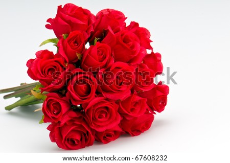 Bouquet of artificial red roses, isolated, space for copy in the side. - stock photo