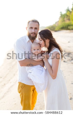 https://thumb9.shutterstock.com/display_pic_with_logo/3083072/584488612/stock-photo-young-beautiful-family-with-a-child-on-the-beach-man-and-woman-with-baby-happy-in-love-relaxing-on-584488612.jpg