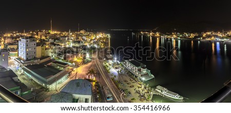 Kien Giang, Vietnam - April 8th, 2015: Panorama beauty of Ha Tien town at night with skyscrapers and lights marina along river to port makes city more beautiful and sparkling in Kien Giang, Vietnam
