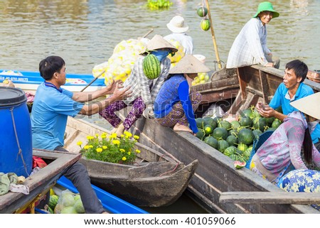 Soc Trang, Vietnam - February 3rd, 2016: Farmers throw your watermelon for goods at floating market is the market early on agricultural trade practices River area of Soc Trang, Vietnam