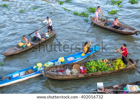 Soc Trang, Vietnam - February 3rd, 2016: Customers go market on river for women with colorful rowing boats clothes shopping agricultural products in morning floating market Soc Trang, Vietnam