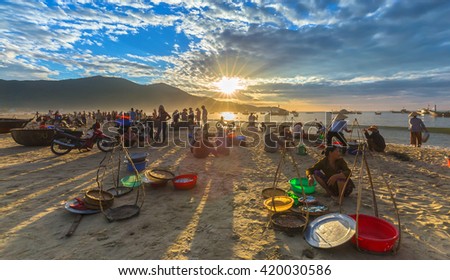 Da Nang, Vietnam, June 26th, 2015: Market fishing when people busy buying selling fish, transport fish, sun rays radiating prepared atmosphere very lively, all living life in Da Nang, Vietnam