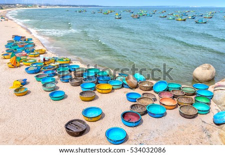 Binh Thuan, Vietnam - July 26th, 2016: Ganh Son Beach on sunny afternoon with many basket boats lined beach, this is beautiful coastline attract tourists to visit in Binh Thuan, Vietnam