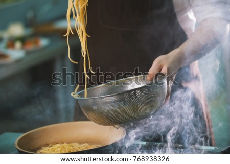 Process of cooking spaghetti in restaurant