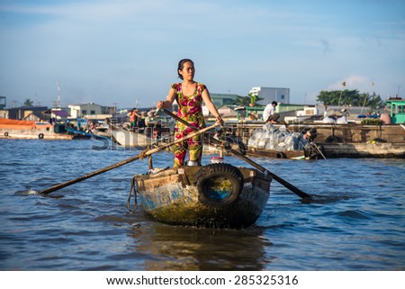 CAN THO, VIETNAM, NOVEMBER 10, 2013: Unidentified woman at floating market in Mekong river delta on November 10, 2013 in Can Tho, Vietnam. Is one of the biggest floating markets on Mekong Delta.