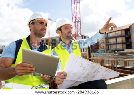 View of a Worker and architect watching some details on a construction