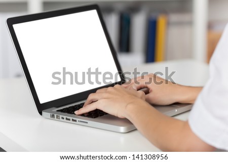 Rear view of business woman hands busy using laptop at office desk, with copyspace