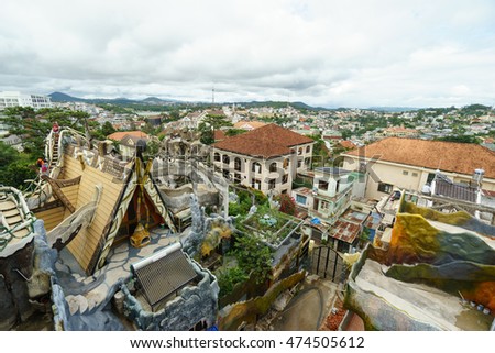 NHA TRANG, VIETNAM - JUNE 23, 2016: View to roofs of fairy tale's buildings in an amusement park and local houses on the background in Vietnam