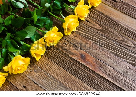 The bouquet of beautiful fresh yellow roses lies on a wooden table.
Card template by St. Valentine's Day or the international Women's Day.