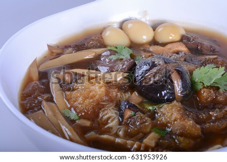 Braised Fish Maw in Red Gravy with crab in bowl on white background.
