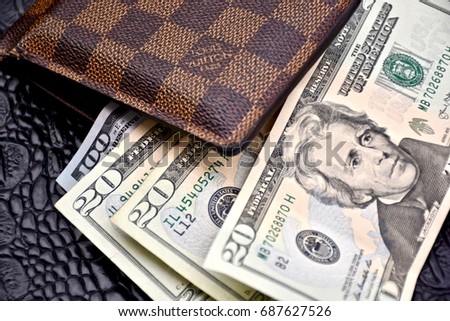 WASHINGTON DC, USA - JULY 31, 2017: Louis Vuitton mens wallet with United States cash.