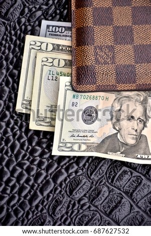 WASHINGTON DC, USA - JULY 31, 2017: Louis Vuitton mens wallet with United States cash.