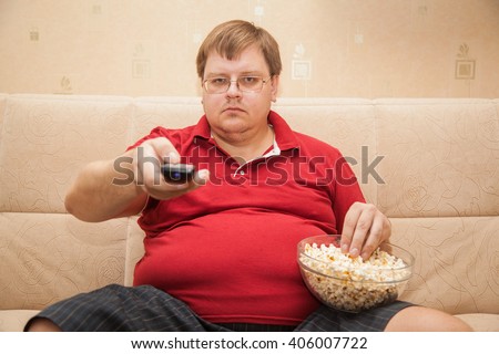 stock-photo-fat-man-eating-popcorn-40600