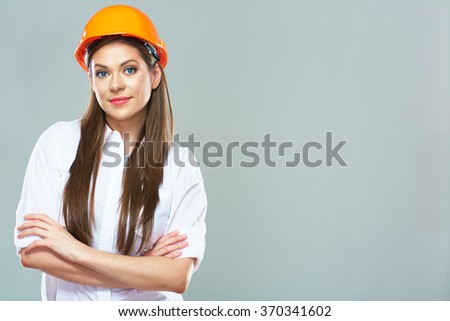 Architect woman isolated portrait with crossed arms. Woman wearing protect helmet.
